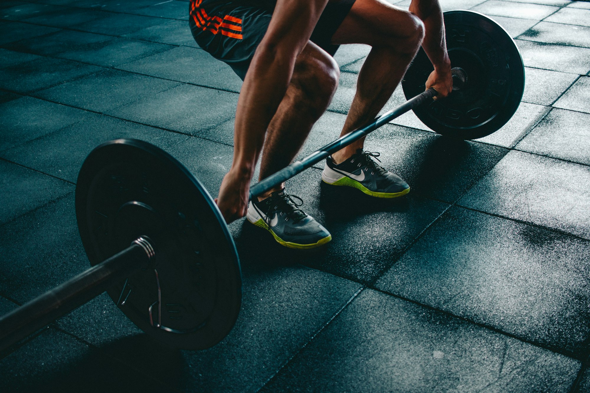 Athlete preparing to deadlift a loaded barbell